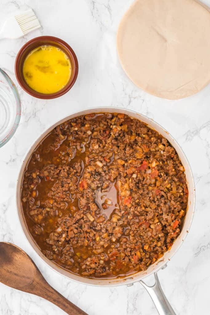 Add beef broth to the skillet and simmer until the liquid has reduced and thickened slightly, about 5-7 minutes. Remove from heat and let cool.