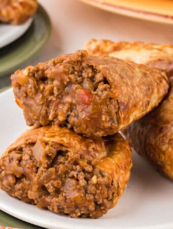 closeup of a beef empanada split in half to show the saucy inside