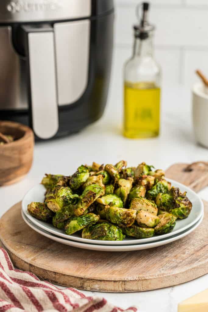 roasted brussels sprouts on plate with aur fryer in background