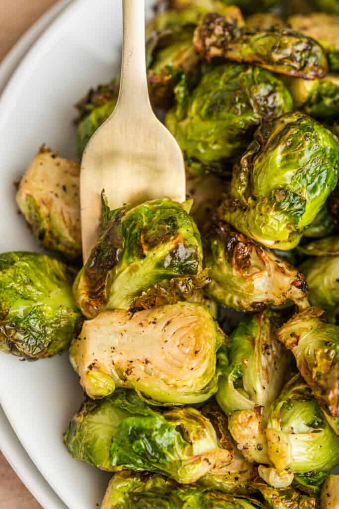 closeup of brussels sprouts on plate with fork