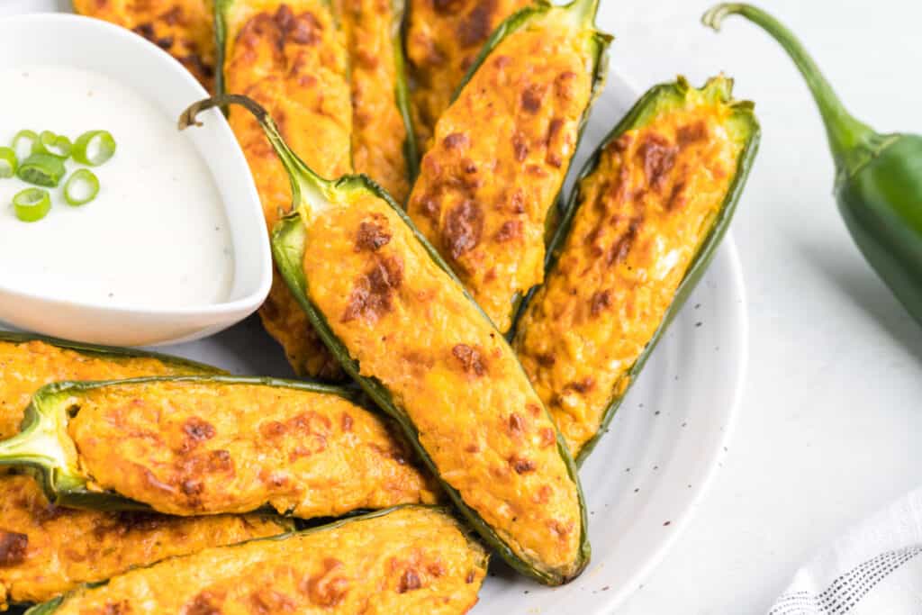 buffalo chicken jalapeno poppers on plate with dip