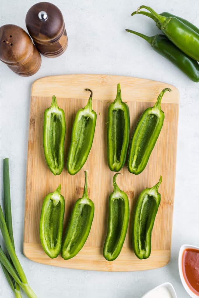 Cut the jalapenos in half lengthways, remove the seeds and membranes, and then set aside.