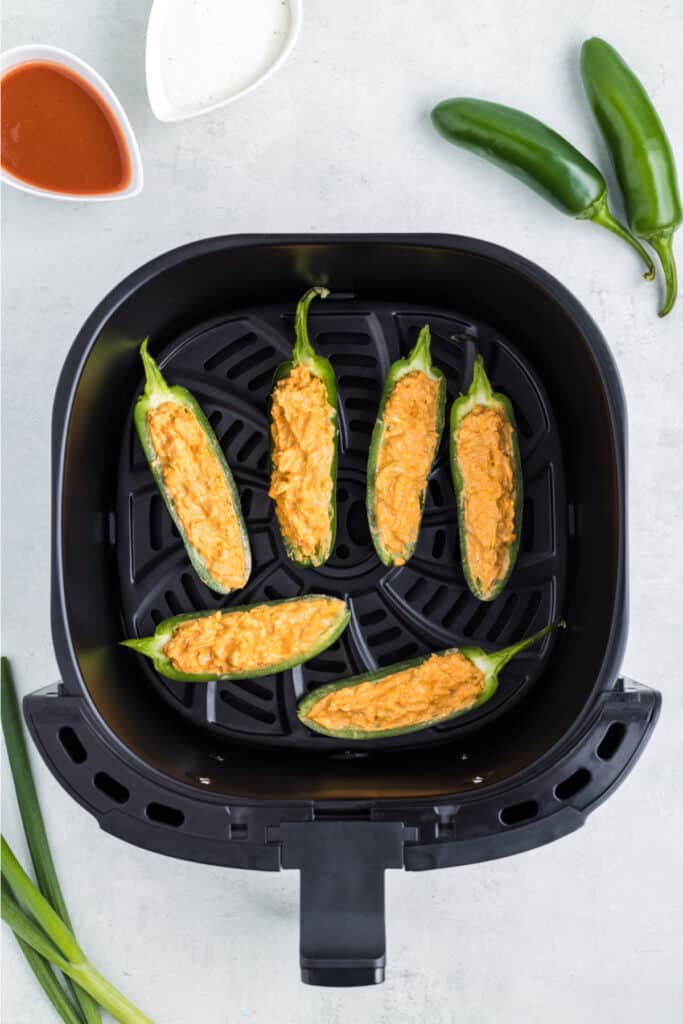 Add a single layer of jalapenos to the air fryer. Cook at 375 degrees F for 5-8 minutes or until the filling is bubbly and golden and the peppers are tender. You do not need to preheat the air fryer. Depending on your air fryer's size, you may need to cook them in batches.