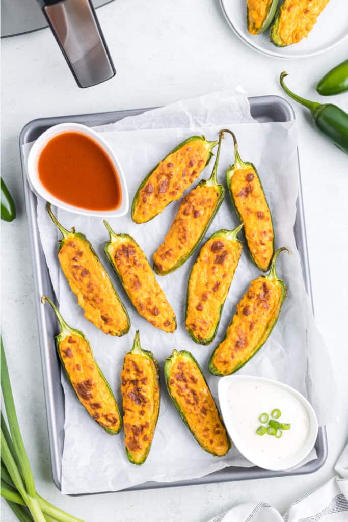 Allow the jalapenos to rest for 3-5 minutes so the filling firms slightly, and serve with ranch, blue cheese dressing, or your favorite dipping sauce.