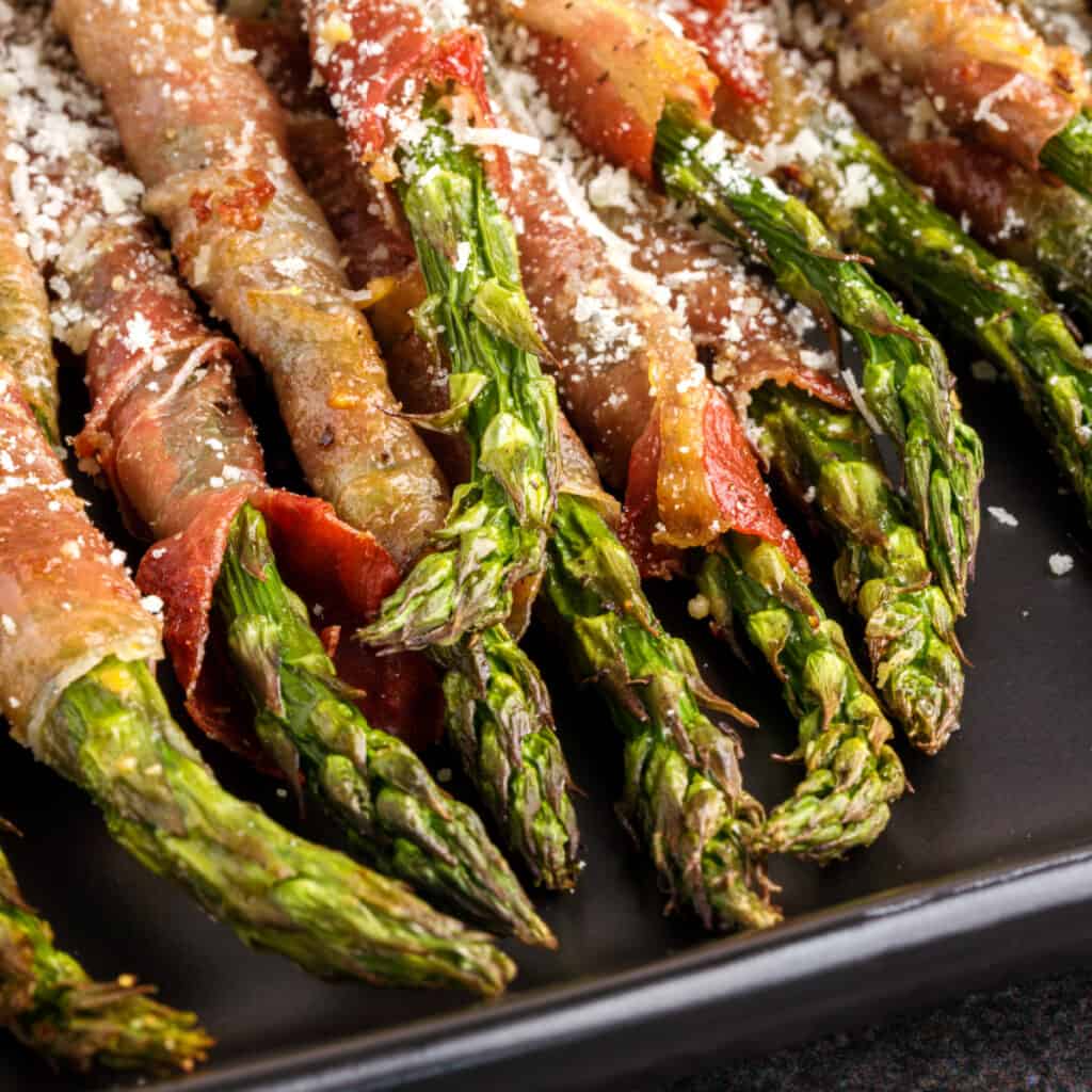 closeup of air fryer prosciutto wrapped asparagus