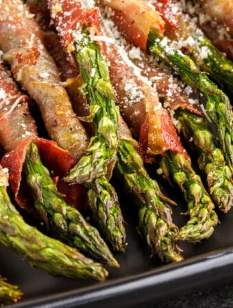 closeup of air fryer prosciutto wrapped asparagus