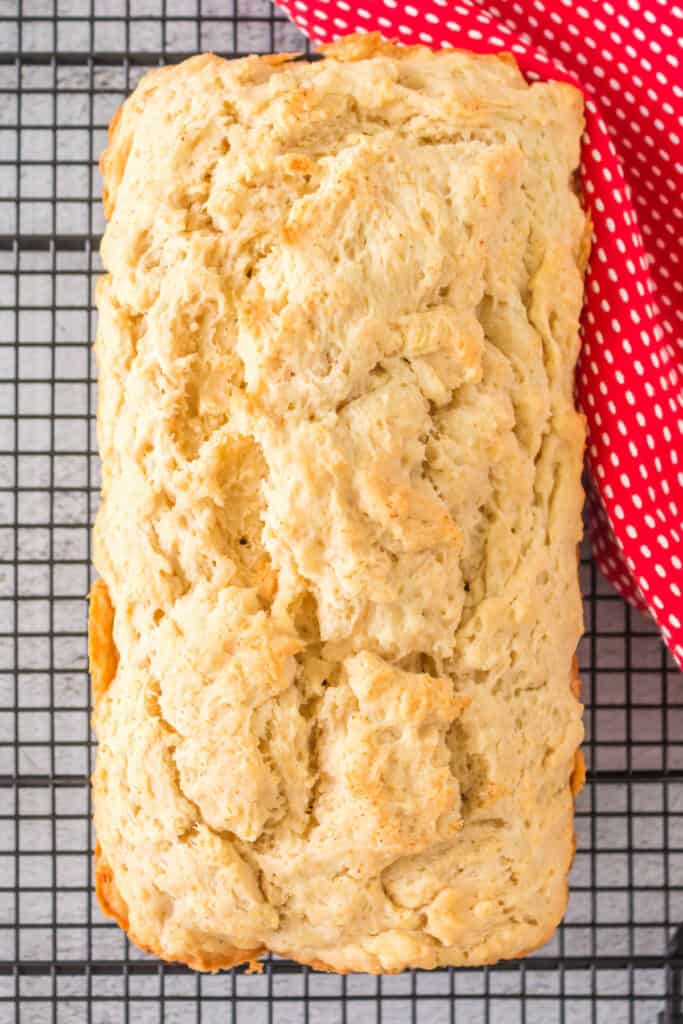 looking down on a loaf of beer quick bread on a wire cooling rack