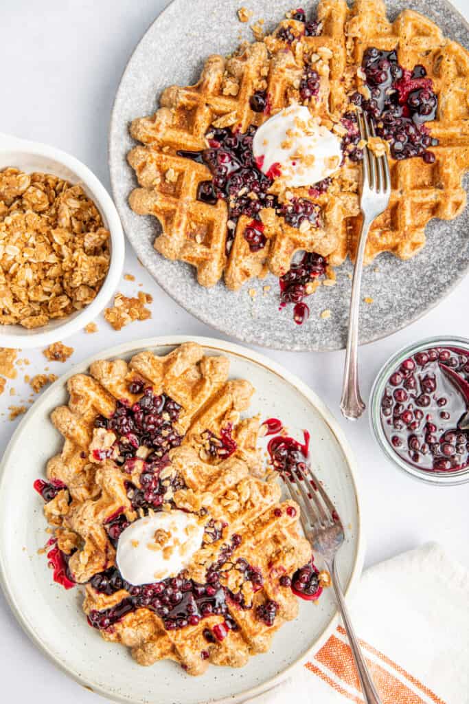 waffles with blueberry sauce on plates