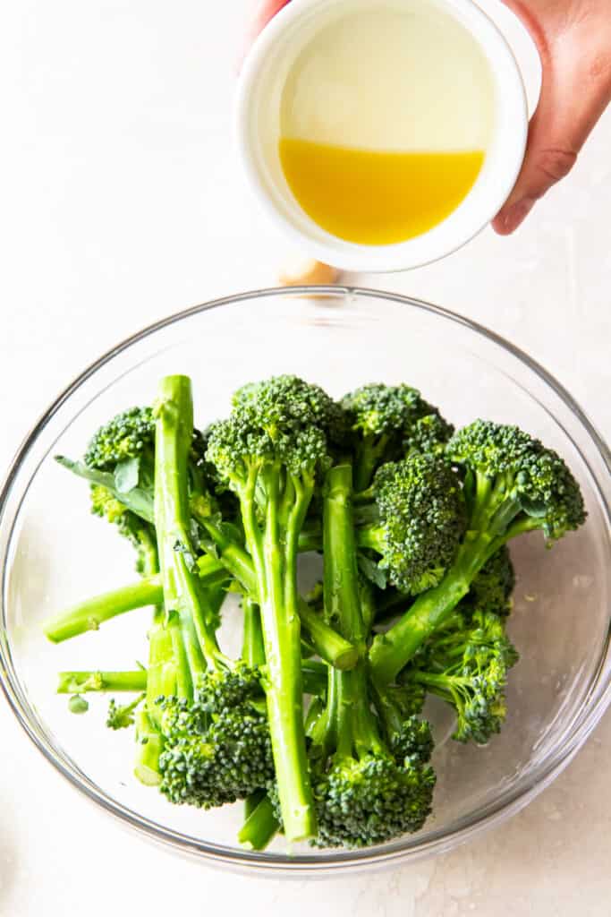 In a large bowl add the broccolini, oil, lemon juice, minced garlic, salt and black pepper.