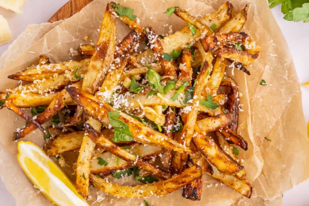 looking down on cooked fries on brown parchment paper