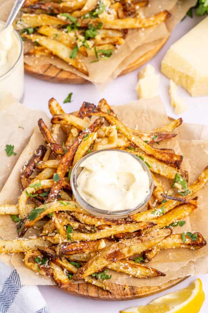 fries arranged in a circle around a bowl of garlic aioli