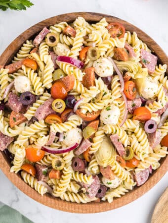closeup of antipasto pasta salad in wooden bowl