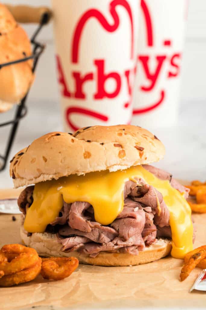 beef and cheddar with arby's cups in the background