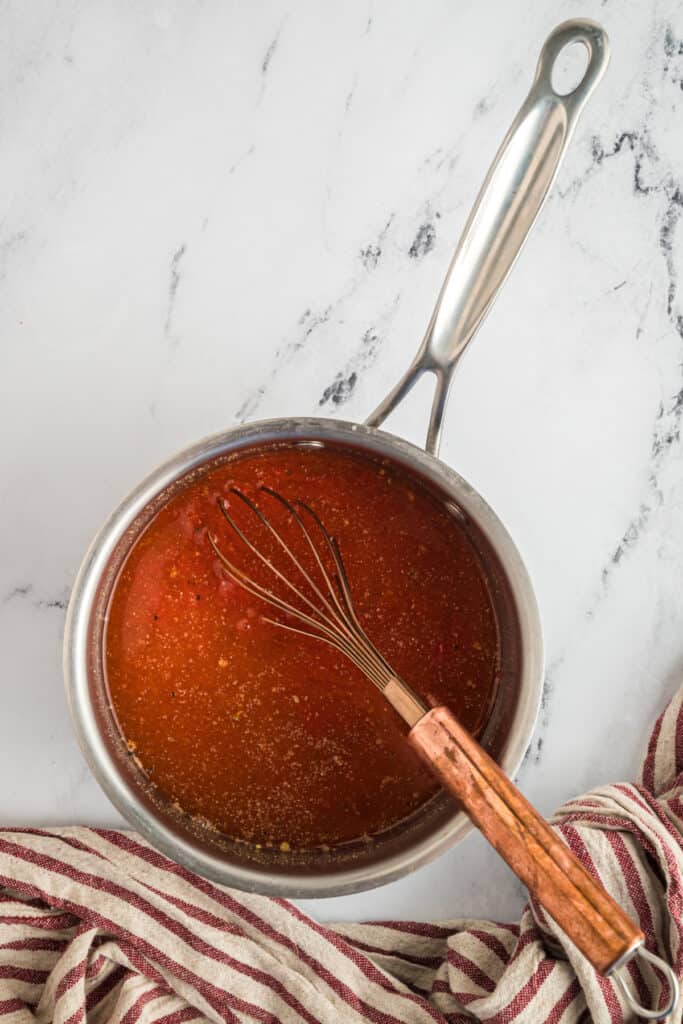 Heat over medium, whisking frequently until the sugar has dissolved and the sauce is just starting to simmer. 