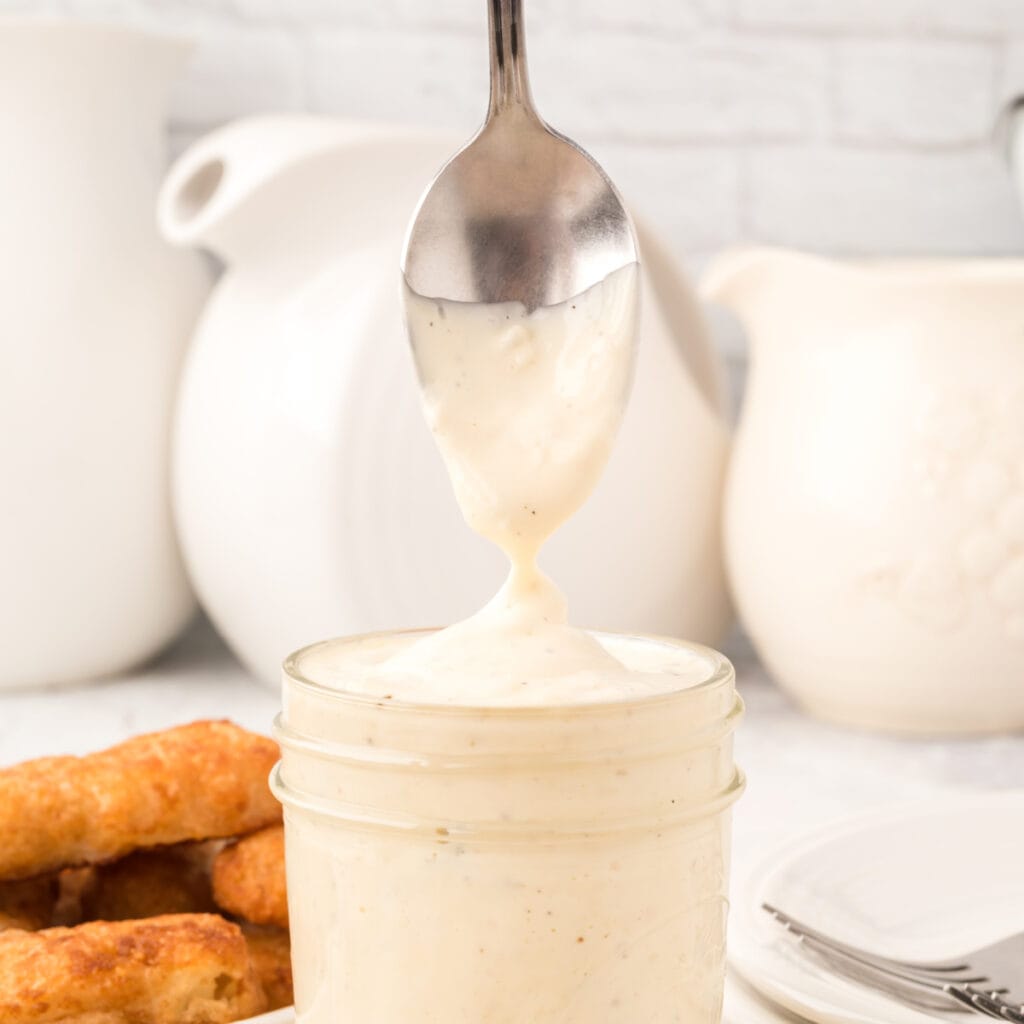 closeup of tartar sauce in jar and on spoon