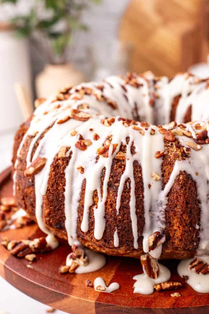 closeup of Hummingbird Bundt Cake after being finished with chopped pecans