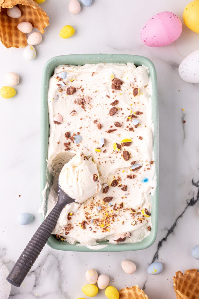no churn cadbury mini egg ice cream in container with scoop