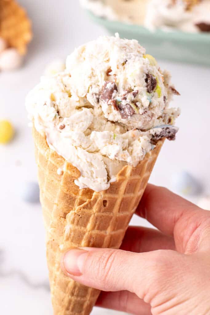 hand holding an ice cream cone with cadbury mini egg ice cream