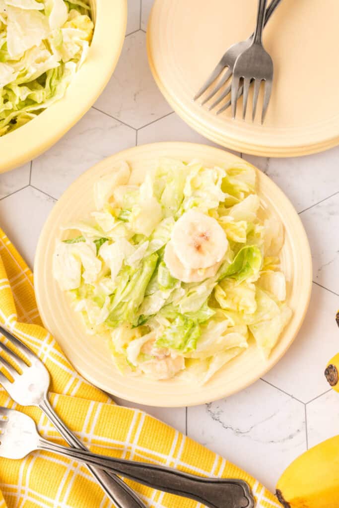 looking straight down onto a plate with banana lettuce salad