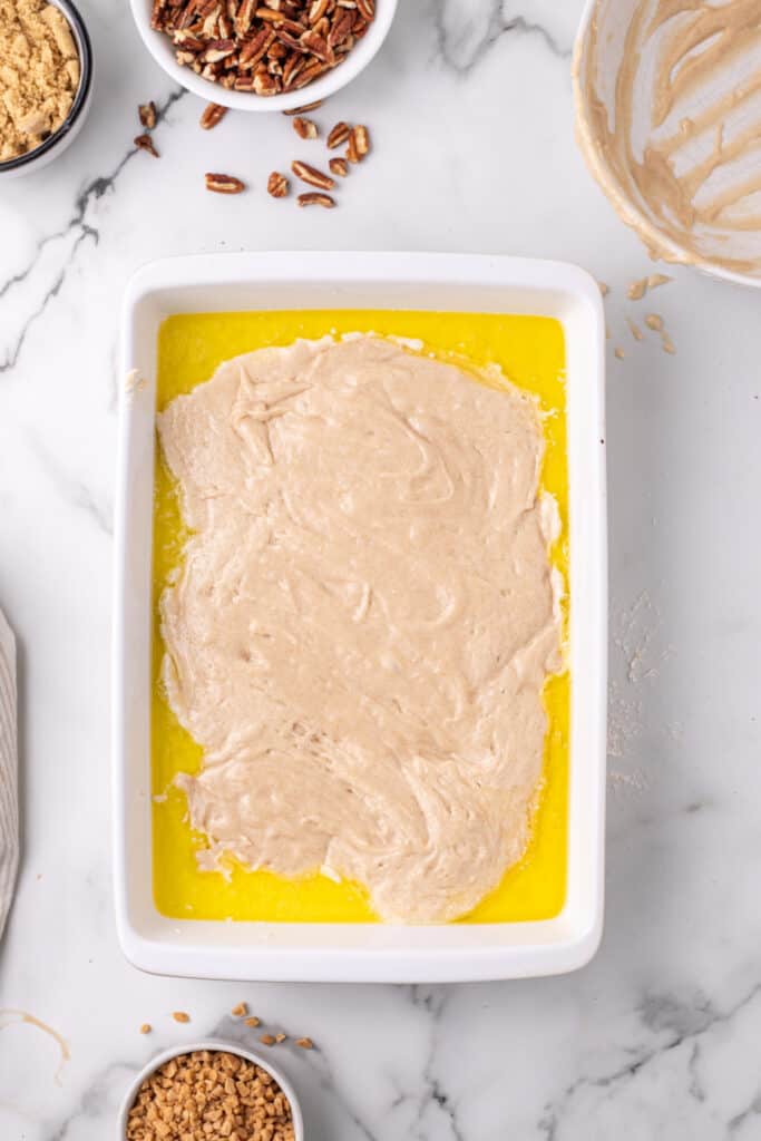 Pecan Pie Cobbler batter and melted butter in baking dish