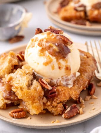 closeup of a scoop of pecan pie cobbler on plate