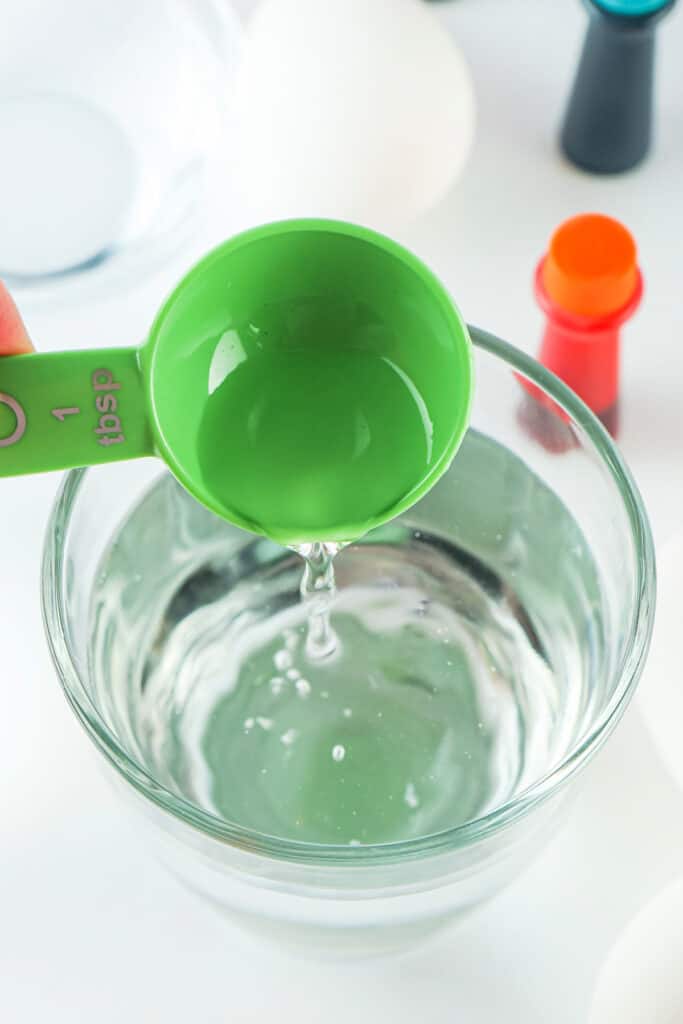 adding vinegar to the water