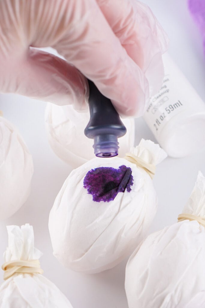 dye being applied to the coffee filter wrapped egg