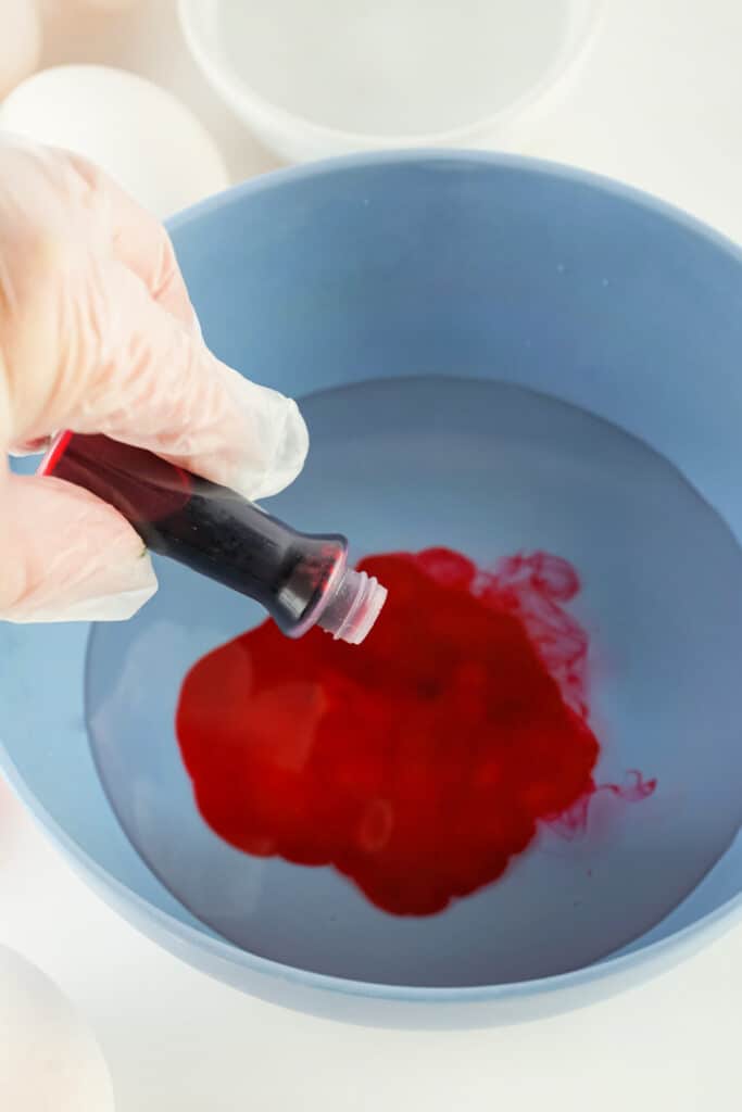 adding food dye to the vinegar-water mixture