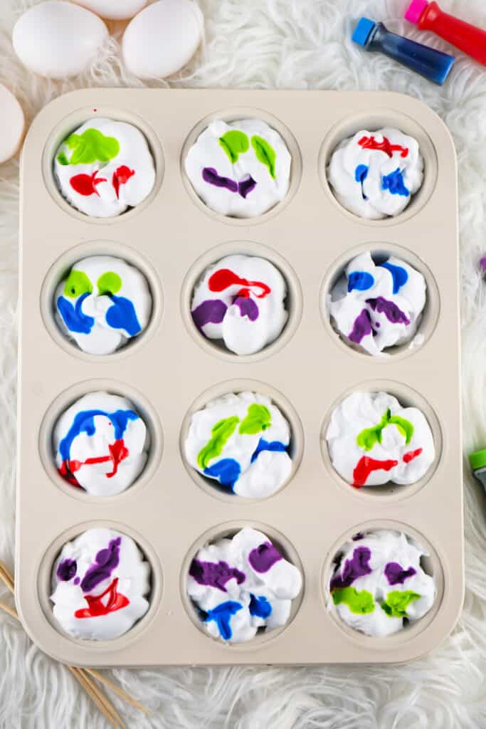 muffin tin filled with shaving cream and assorted colors of dye
