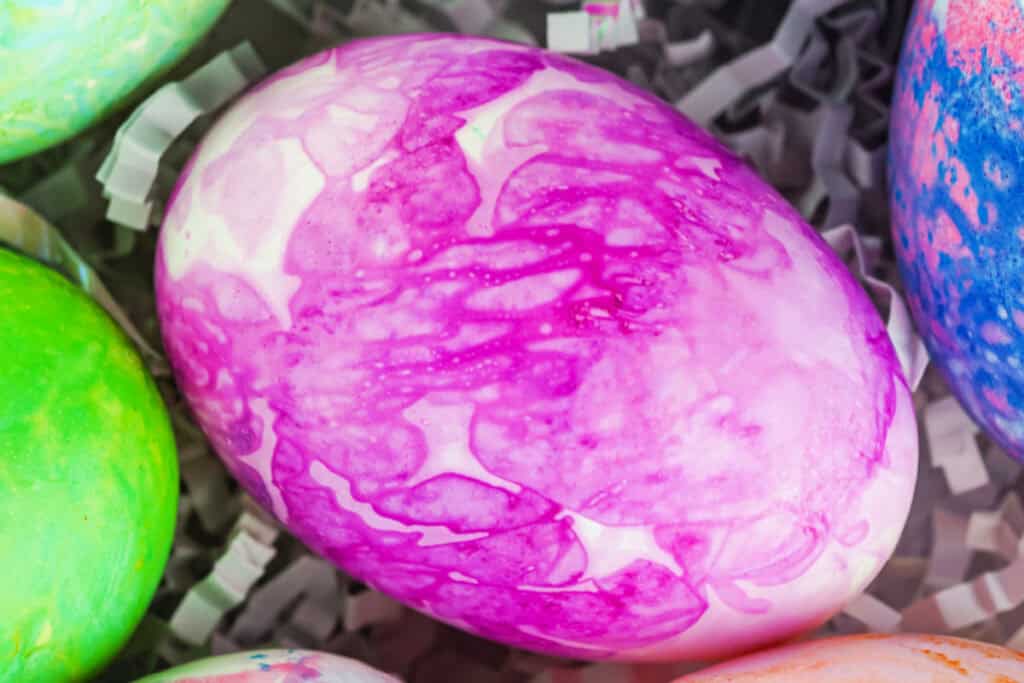 closeup of a pink tissue paper dyed easter egg