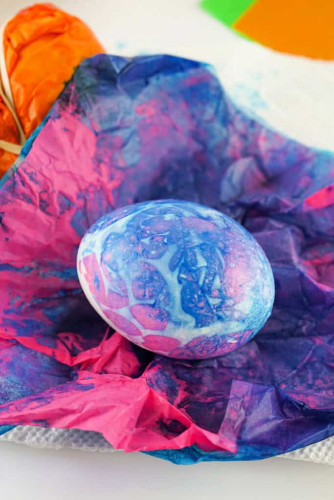 unwrapped tissue paper dyed easter egg showing the color transfer