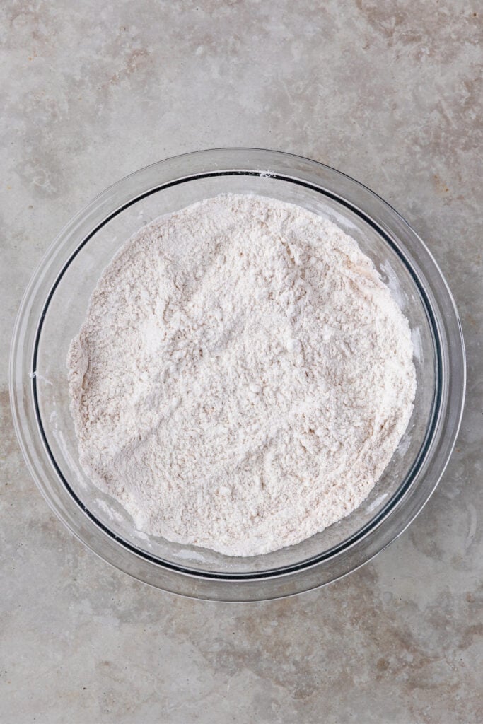 Dry ingredients including flour and cinnamon mixed together in a separate bowl.