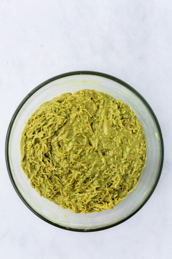 Final filling mixture of pistachio butter, tahini, and toasted kataifi fully combined in a glass bowl.