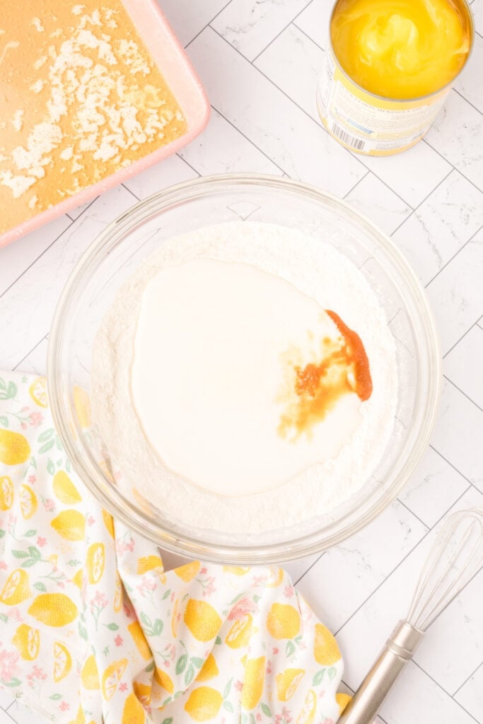 Buttermilk, lemon extract, and vanilla poured over flour and sugar mixture