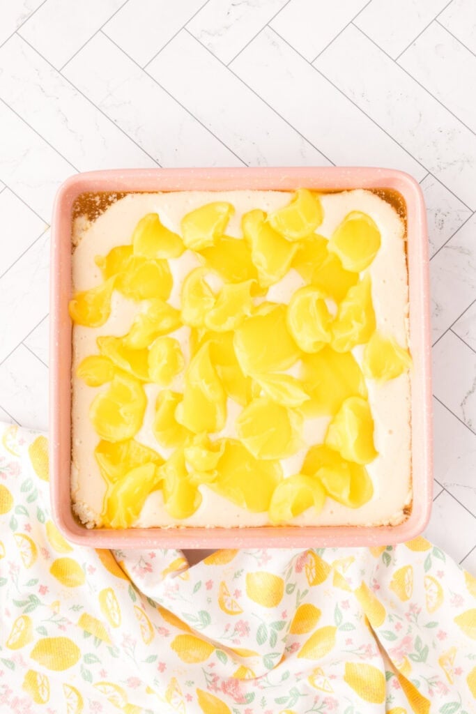 Dollops of lemon pie filling spooned over the batter in the baking dish