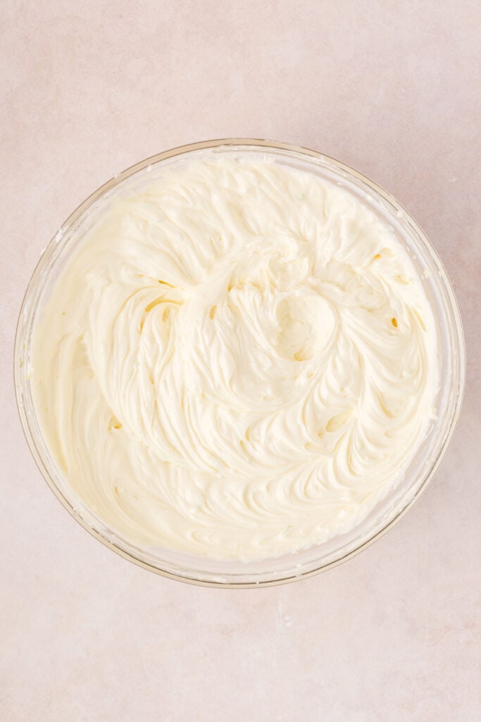 Creamy cheesecake filling being mixed until smooth