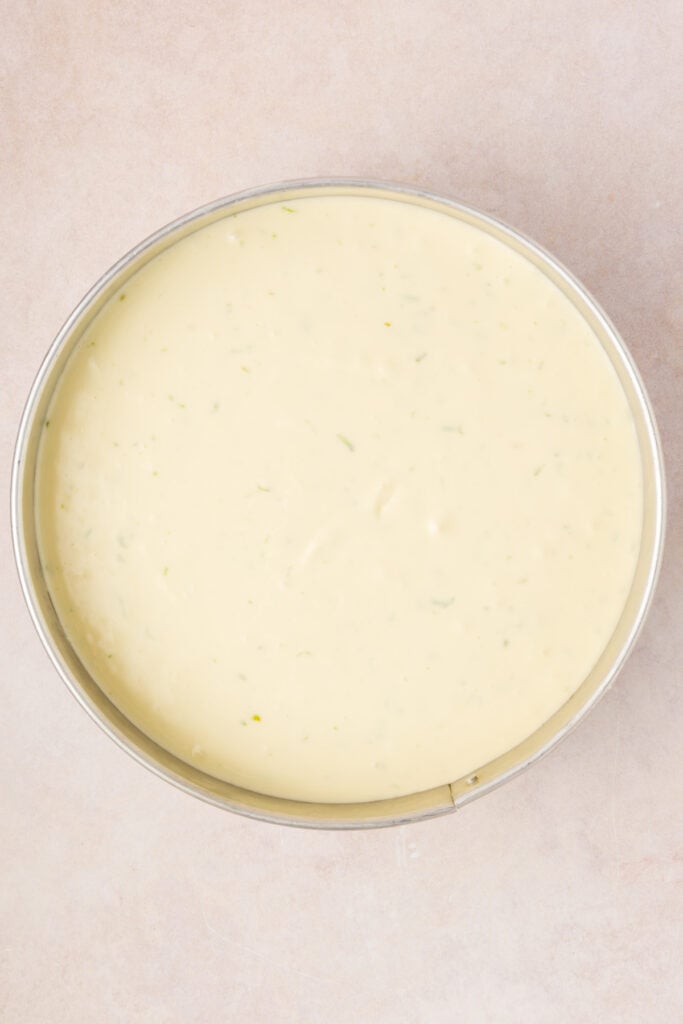 Cheesecake batter poured into the crust in a springform pan