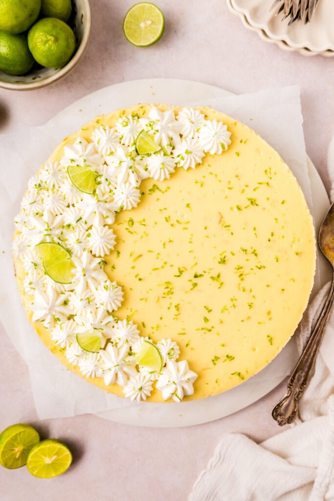 Overhead view of finished Key Lime Cheesecake with decorative whipped topping