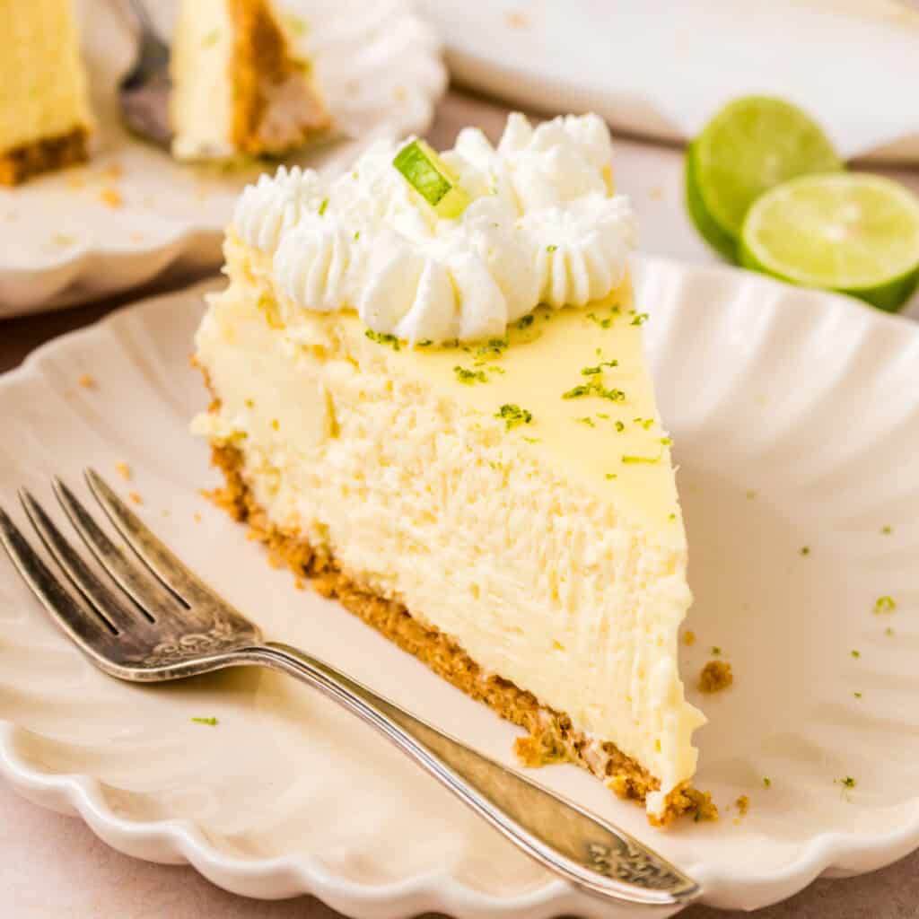closeup of a slice of key lime cheesecake on plate