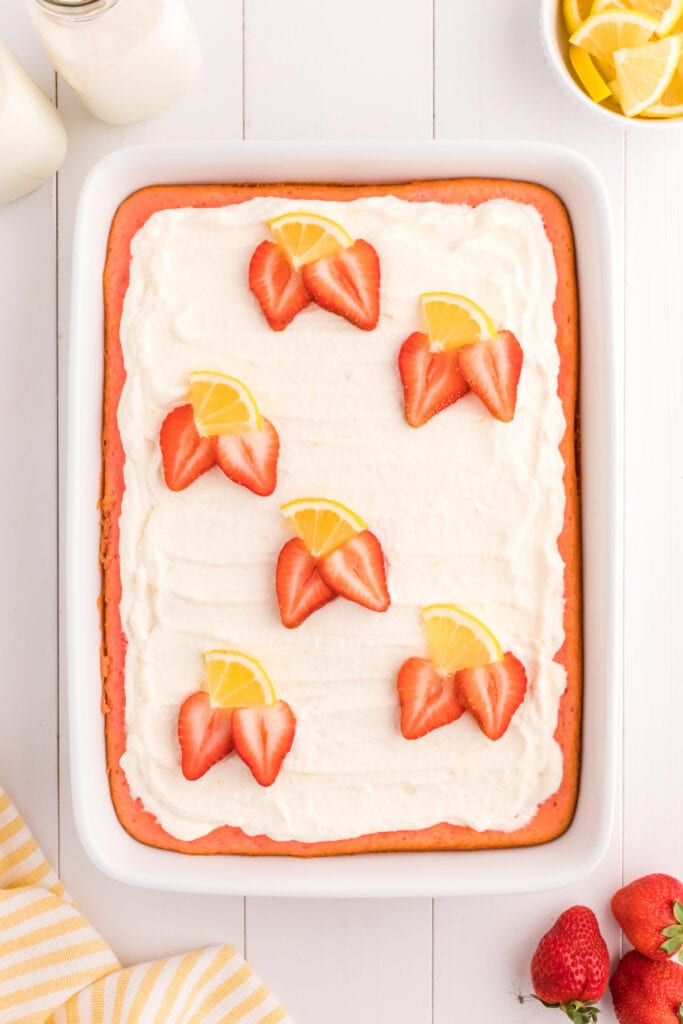 finished cake topped with strawberry and lemon slices