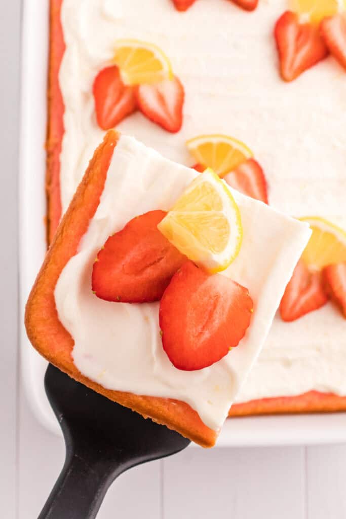 slice of cake on spatula being lifted from baking dish