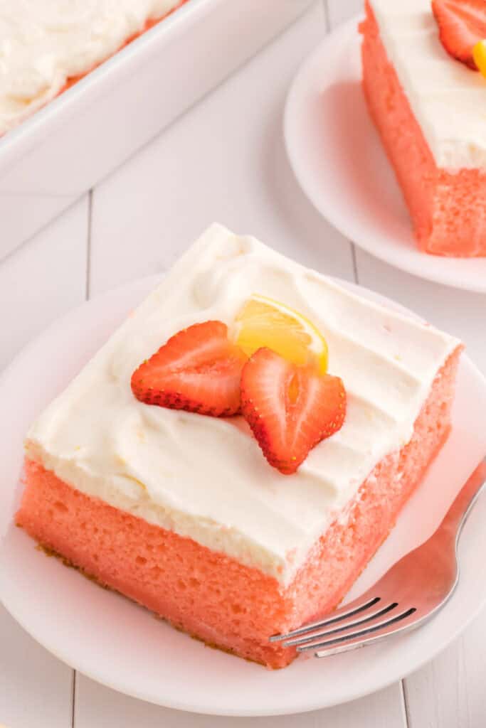 looking down onto a slice of strawberry cake with lemon cream topping