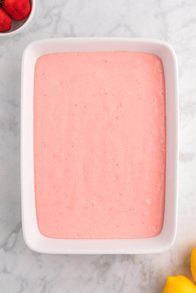 strawberry cake batter in baking dish before being baked