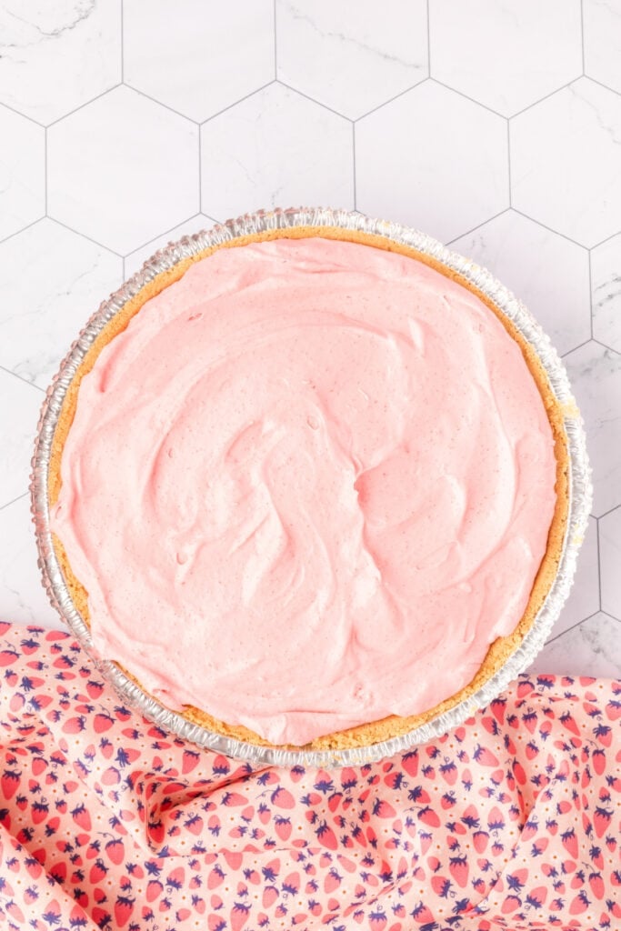 Strawberry filling evenly spread into a prepared graham cracker crust