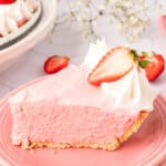 closeup of a slice of strawberry jello cream pie on a plate