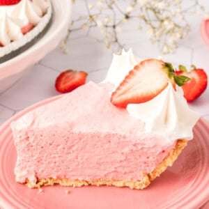 closeup of a slice of strawberry jello cream pie on a plate