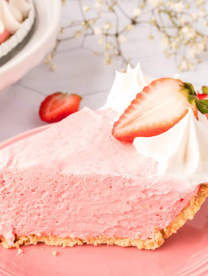 closeup of a slice of strawberry jello cream pie on a plate