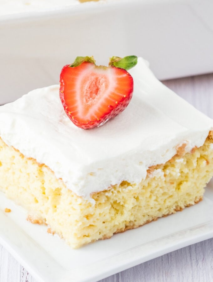 closeup of a slice of tres leches cake on plate