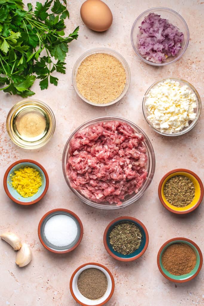 Overhead view of all ingredients for turkey feta meatballs arranged on a countertop