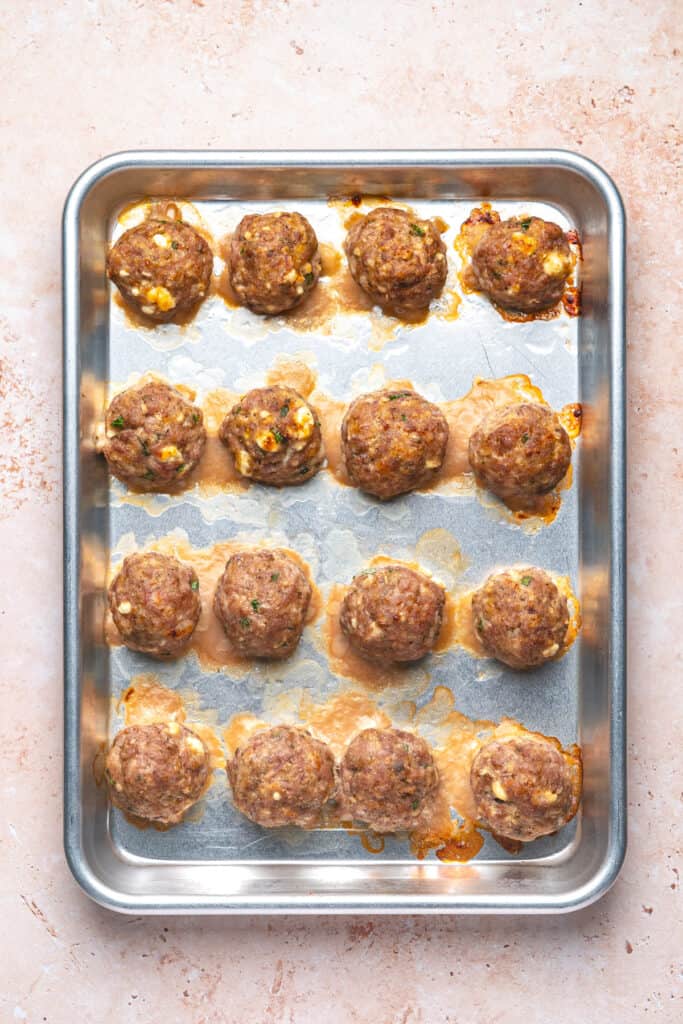 Cooked turkey feta meatballs fresh from the oven with browned tops and melted cheese